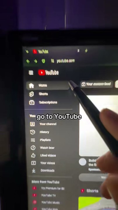 Pen pointing at the YouTube home screen