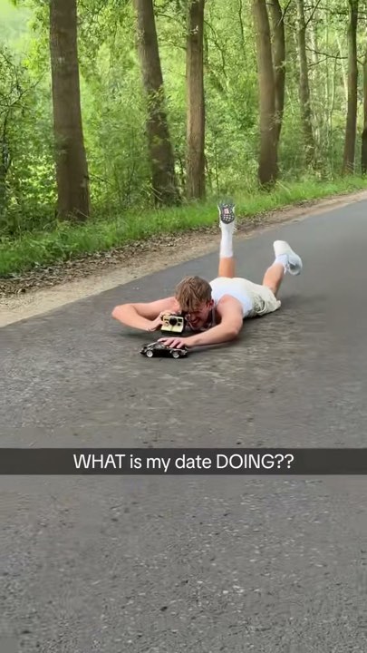 wernervfx lying on a road with a toy camera and model car